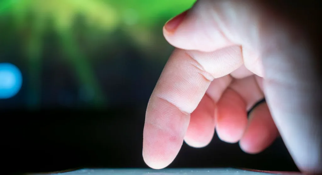Close-up of a finger interacting with a touchscreen, capturing a moment of technology use